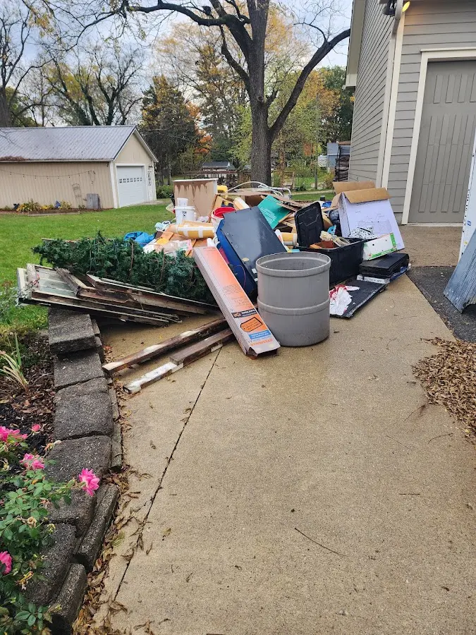 Dumpster being loaded with debris for Estate Cleanout Dumpster Rental in Morehead